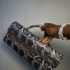 Handmade leather curved flap bag in chocolate snake skin