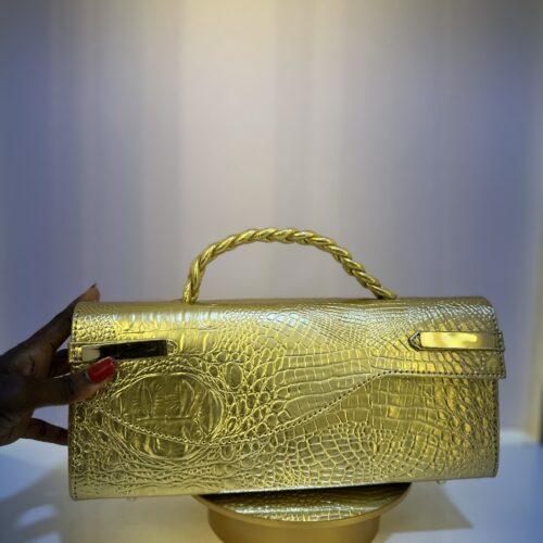 Croc leather Curved flap bag in Gold- The braids Brand