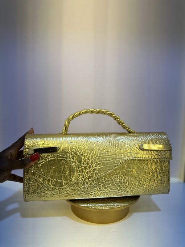 Croc leather Curved flap bag in Gold- The braids Brand