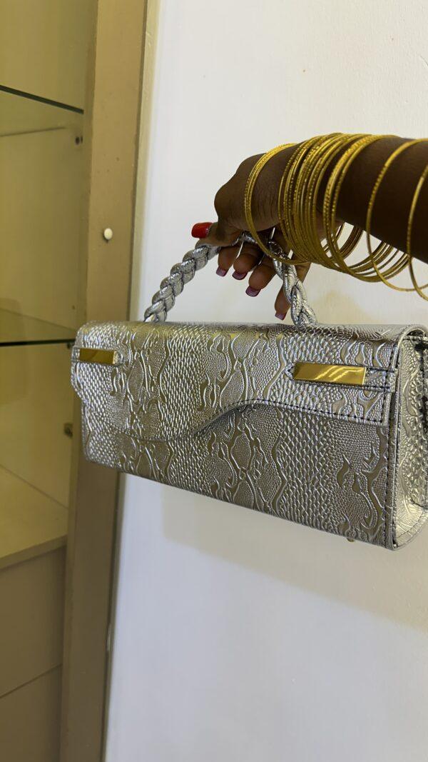 Curved flap leather bag in silver - The braids Brand