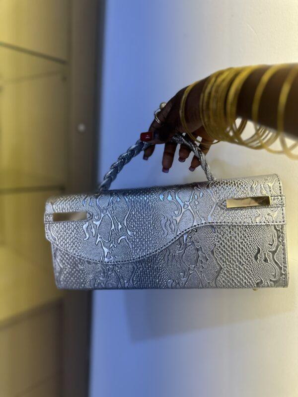 Curved flap leather bag in silver - The braids Brand