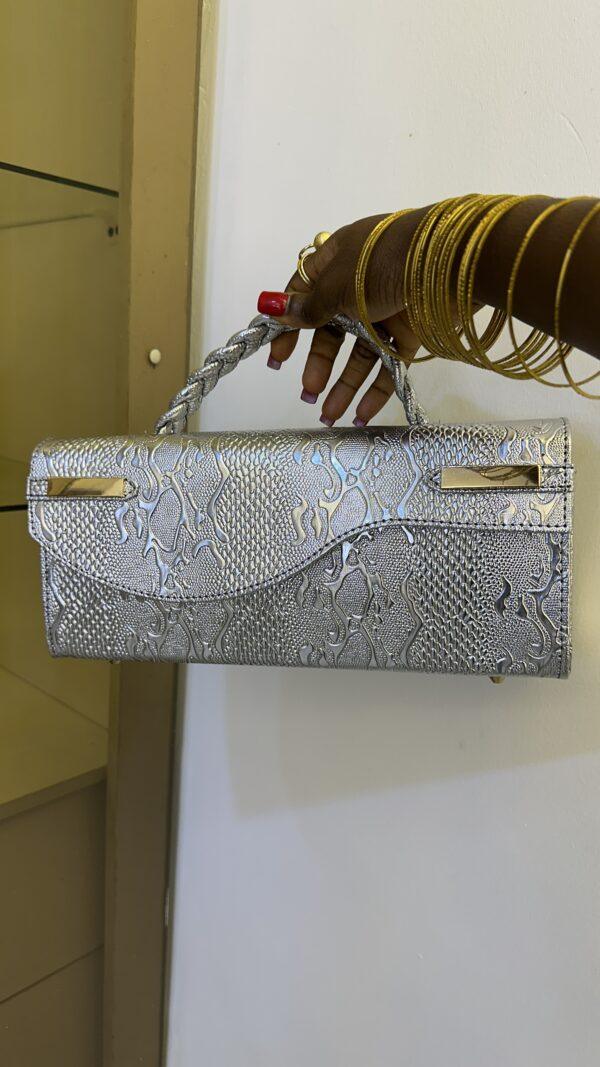 Curved flap leather bag in silver - The braids Brand