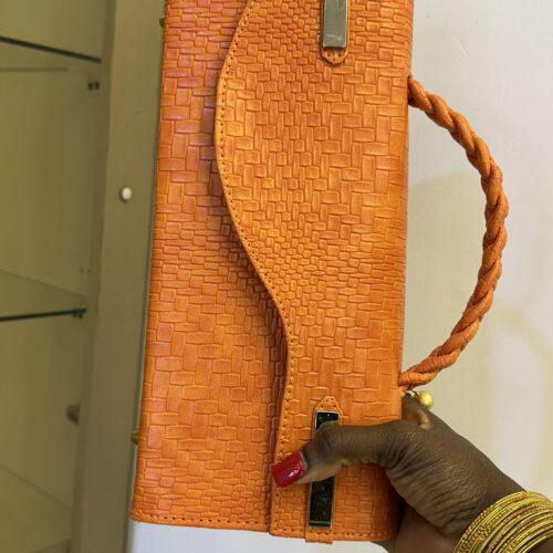 The Enyonam Bag (4) Curved Flap leather bag in orange - The braids Brand