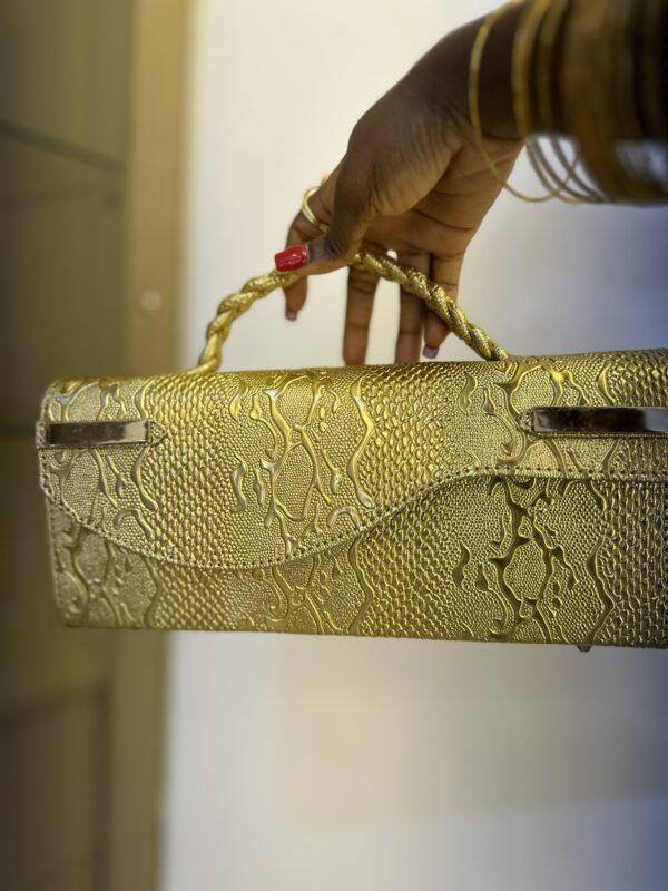 Curved flap bag in Gold- The braids Brand