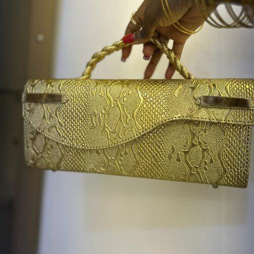 Curved flap bag in Gold- The braids Brand