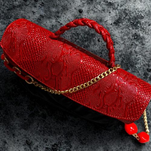 Red cylindrical leather bag